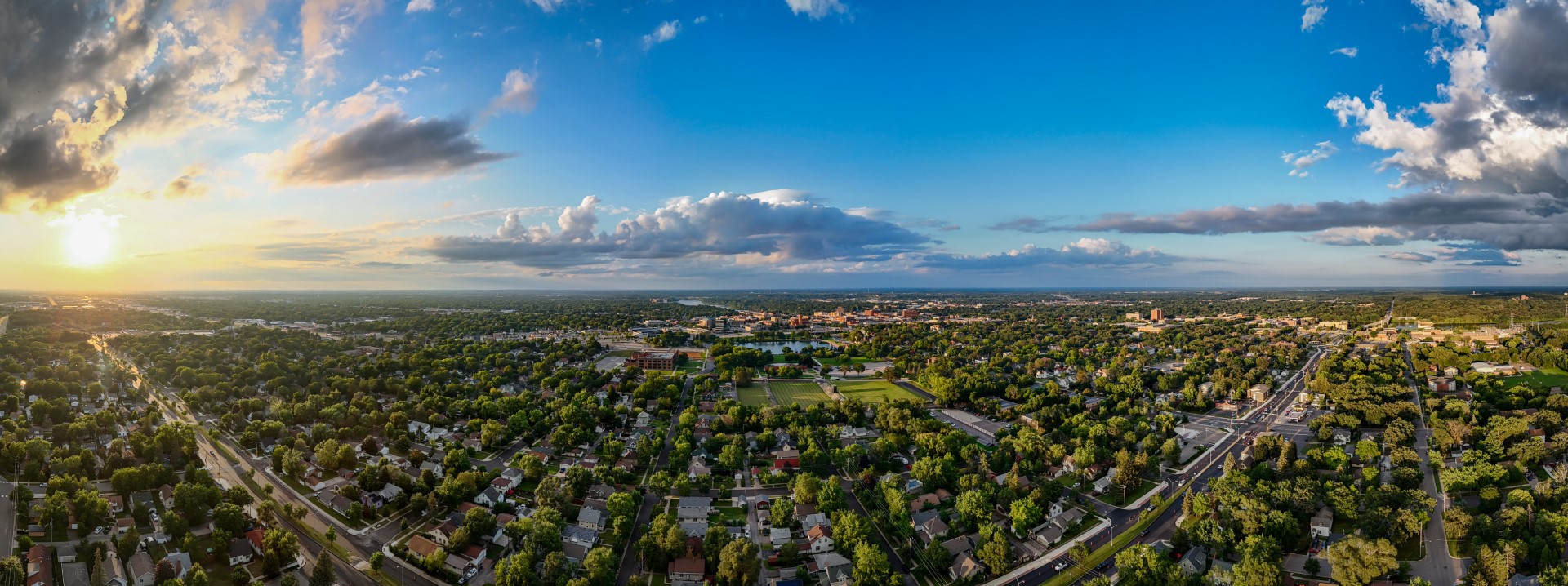 Aerial panorama of St. Cloud beneath a blue and gold evening sky.